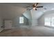 Spacious carpeted bonus room featuring vaulted ceilings and natural light at 214 Jamestown Ave, Jonesboro, GA 30236