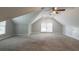 Spacious carpeted bonus room featuring vaulted ceilings and natural light at 214 Jamestown Ave, Jonesboro, GA 30236