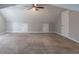 Spacious carpeted bonus room featuring vaulted ceilings and natural light at 214 Jamestown Ave, Jonesboro, GA 30236