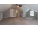 Spacious carpeted bonus room featuring vaulted ceilings and natural light at 214 Jamestown Ave, Jonesboro, GA 30236