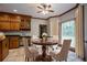 Bright breakfast nook with a wood table, plush chairs, large window, and built-in wood cabinets at 214 Jamestown Ave, Jonesboro, GA 30236