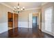 Formal dining room with hardwood floors, paneled walls, modern chandelier, and an open layout at 214 Jamestown Ave, Jonesboro, GA 30236