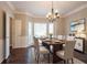 Elegant dining room with chandelier, large window, and wainscoting at 214 Jamestown Ave, Jonesboro, GA 30236