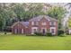 Traditional brick home with manicured lawn and mature landscaping at 214 Jamestown Ave, Jonesboro, GA 30236