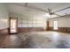 Large two-car garage featuring wall shelving for storage and easy access to the home's interior at 214 Jamestown Ave, Jonesboro, GA 30236
