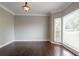 Well-lit living room featuring hardwood floors, neutral paint, and an abundance of natural light at 214 Jamestown Ave, Jonesboro, GA 30236