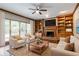 Living room featuring a fireplace with custom wood built-ins and a large window at 214 Jamestown Ave, Jonesboro, GA 30236