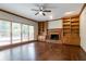 Cozy living room with fireplace, built-in bookshelves, and hardwood floors at 214 Jamestown Ave, Jonesboro, GA 30236