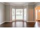 Bright living room with bay window features hardwood floors, neutral paint, and ample natural light at 214 Jamestown Ave, Jonesboro, GA 30236