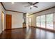 Spacious living room features hardwood floors, a dry bar, and large windows with backyard views at 214 Jamestown Ave, Jonesboro, GA 30236