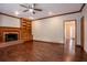 Cozy living room features hardwood floors, a brick fireplace, and built-in shelving at 214 Jamestown Ave, Jonesboro, GA 30236