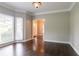 Bright living room features hardwood floors, neutral paint, bay windows, and an open entrance at 214 Jamestown Ave, Jonesboro, GA 30236