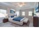 Stylized main bedroom with decorative tray ceiling, ceiling fan, and picture window at 214 Jamestown Ave, Jonesboro, GA 30236