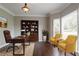 Well-lit home office with large windows, hardwood floors, and built-in bookcase at 214 Jamestown Ave, Jonesboro, GA 30236