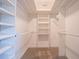 Spacious walk-in closet featuring a ladder for reaching storage, and natural-colored carpeting at 214 Jamestown Ave, Jonesboro, GA 30236
