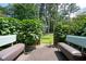 Inviting back patio featuring cozy seating and a serene view of the lush, green backyard at 3322 Northcrest Rd # A, Atlanta, GA 30340