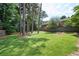 Spacious backyard with lush green grass, mature trees, and privacy fencing, great for outdoor enjoyment at 3322 Northcrest Rd # A, Atlanta, GA 30340