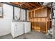 Unfinished basement featuring a washer, a dryer, with brown cabinets and exposed ductwork at 3322 Northcrest Rd # A, Atlanta, GA 30340