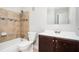Bathroom featuring a tiled shower-tub combo, white toilet, vanity with a dark wood cabinet, and a large mirror at 3322 Northcrest Rd # A, Atlanta, GA 30340