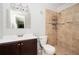 This bathroom offers a stand-up shower with decorative tile, a vanity, and a toilet at 3322 Northcrest Rd # A, Atlanta, GA 30340