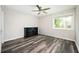 Bright bedroom features hardwood floors, neutral walls, a dresser, and a large window at 3322 Northcrest Rd # A, Atlanta, GA 30340