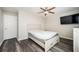 Cozy bedroom offers hardwood floors, a modern ceiling fan, a TV, and a closet at 3322 Northcrest Rd # A, Atlanta, GA 30340