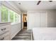Bedroom includes hardwood floors, a large window, a closet, and access to a private bathroom at 3322 Northcrest Rd # A, Atlanta, GA 30340