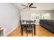 Bright dining room features hardwood floors, a modern ceiling fan, and a view to the backyard at 3322 Northcrest Rd # A, Atlanta, GA 30340