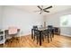 Cozy dining room with hardwood floors, a stylish ceiling fan, and a view of the backyard, ideal for Gathering meals at 3322 Northcrest Rd # A, Atlanta, GA 30340