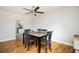 Bright dining room features hardwood floors, a modern ceiling fan, and a view into the kitchen at 3322 Northcrest Rd # A, Atlanta, GA 30340
