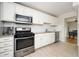 Modern kitchen featuring stainless steel appliances, granite countertops, and white cabinetry, designed for functionality and style at 3322 Northcrest Rd # A, Atlanta, GA 30340