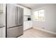 Well-lit kitchen featuring stainless steel refrigerator, ample counter space, and modern cabinetry, offering convenience and efficiency at 3322 Northcrest Rd # A, Atlanta, GA 30340