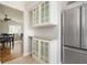 Elegant kitchen featuring granite countertops, stainless steel refrigerator, and glass-front cabinetry, combining style and functionality at 3322 Northcrest Rd # A, Atlanta, GA 30340