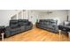 Spacious living room featuring hardwood floors, two comfortable sofas, and stylish decor, perfect for relaxing and entertaining at 3322 Northcrest Rd # A, Atlanta, GA 30340