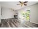 The bright living room features a modern floor, a sliding glass door, and dual ceiling fans at 3322 Northcrest Rd # A, Atlanta, GA 30340