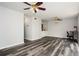 Spacious living room featuring modern floors, dual ceiling fans, and built-in shelving at 3322 Northcrest Rd # A, Atlanta, GA 30340