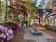 Landscaped backyard featuring a stone paver patio, fountain, gazebo, and mature trees at 905 Stovall Ne Blvd, Atlanta, GA 30319