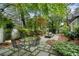 Outdoor patio with dining table, landscaped garden, fountain, and gazebo is ready for entertaining at 905 Stovall Ne Blvd, Atlanta, GA 30319