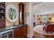 Elegant bar area with granite countertop, wine fridge, and custom cabinetry at 905 Stovall Ne Blvd, Atlanta, GA 30319