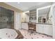 Bright bathroom with whirlpool tub, glass shower, and dual vanities at 905 Stovall Ne Blvd, Atlanta, GA 30319