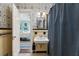 Charming bathroom features a pedestal sink, tiled floors, and unique wallpaper at 905 Stovall Ne Blvd, Atlanta, GA 30319
