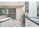 Bright bathroom with whirlpool tub, glass shower, and dual vanities at 905 Stovall Ne Blvd, Atlanta, GA 30319