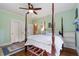 Bedroom with a four-poster bed, hardwood floors, and access to the hallway at 905 Stovall Ne Blvd, Atlanta, GA 30319
