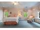 Inviting bedroom with an ornate iron bed frame, blue carpet, and natural light at 905 Stovall Ne Blvd, Atlanta, GA 30319