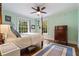 Light-filled bedroom with hardwood floors, a four-poster bed, and two bright windows at 905 Stovall Ne Blvd, Atlanta, GA 30319