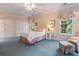 Comfortable bedroom with pastel pink walls, blue carpet, and two large windows at 905 Stovall Ne Blvd, Atlanta, GA 30319
