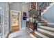 Welcoming entryway with staircase, travertine floors, and ample natural light from the front door at 905 Stovall Ne Blvd, Atlanta, GA 30319