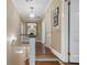 Upstairs hallway features a decorative chandelier and hardwood floors at 905 Stovall Ne Blvd, Atlanta, GA 30319