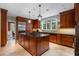 Kitchen with a large island, stainless steel appliances, wood cabinets, and tile floors offering a gourmet cooking space at 905 Stovall Ne Blvd, Atlanta, GA 30319