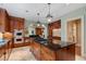 Spacious kitchen featuring dark wood cabinets, a center island with cooktop, and stainless steel appliances at 905 Stovall Ne Blvd, Atlanta, GA 30319